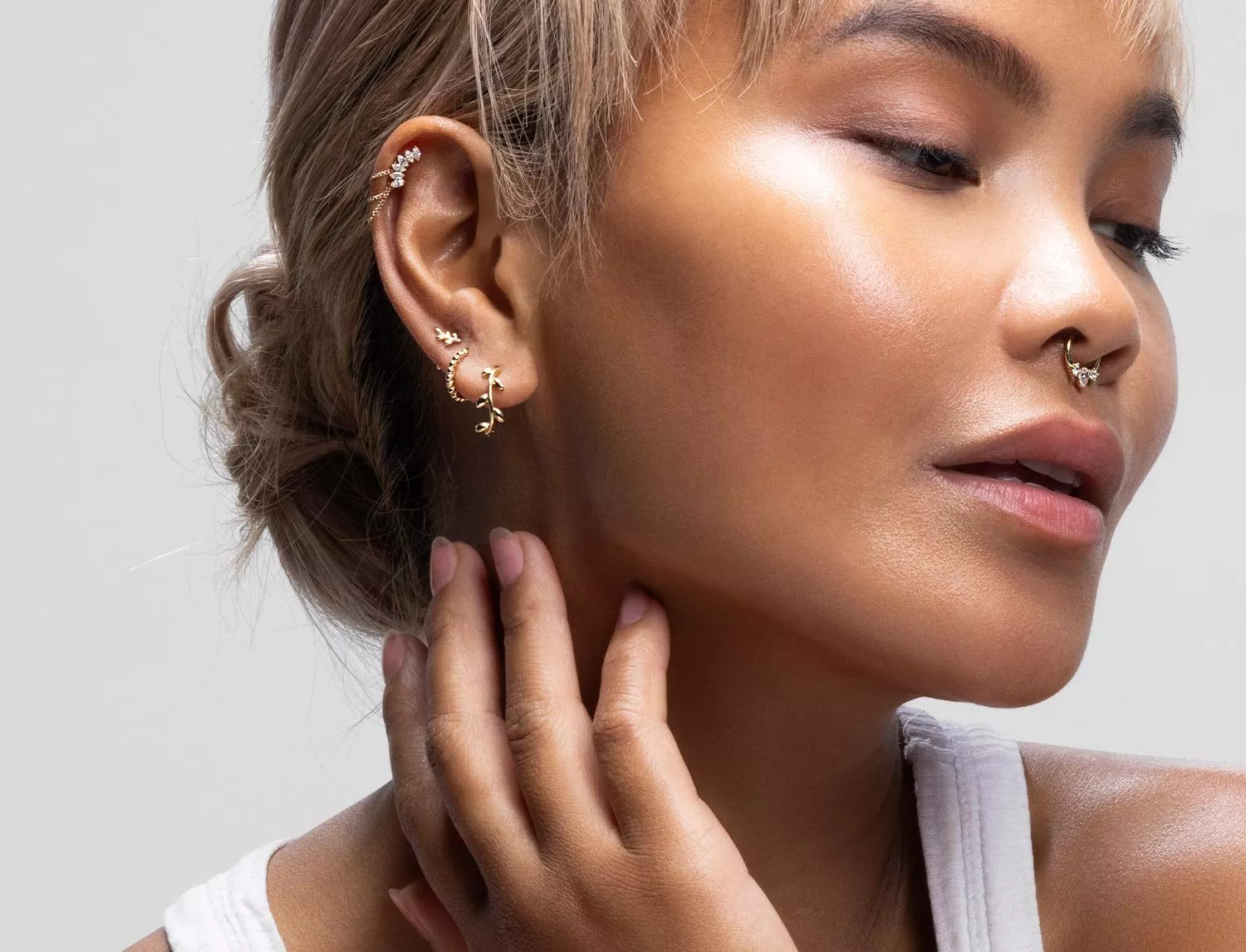 lady with multiple ear piercings and a nose ring