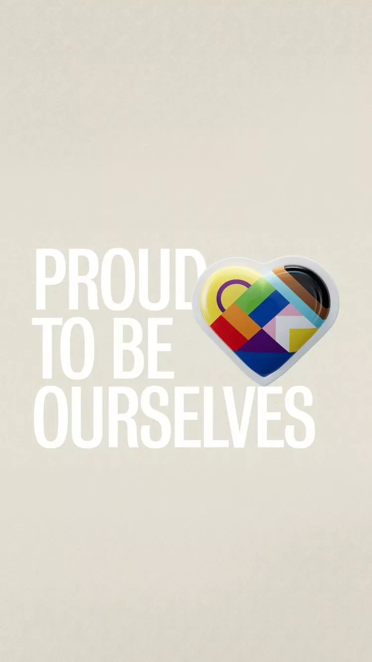 “Proud to be ourselves” with heart icon in LGBTQ+ flag colours on beige background