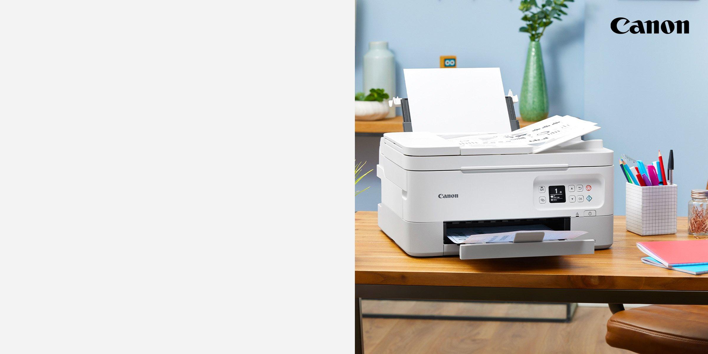 Printer on table next to pencil pot and books