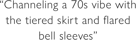 “Channeling a 70s vibe with the tiered skirt and flared bell sleeves”