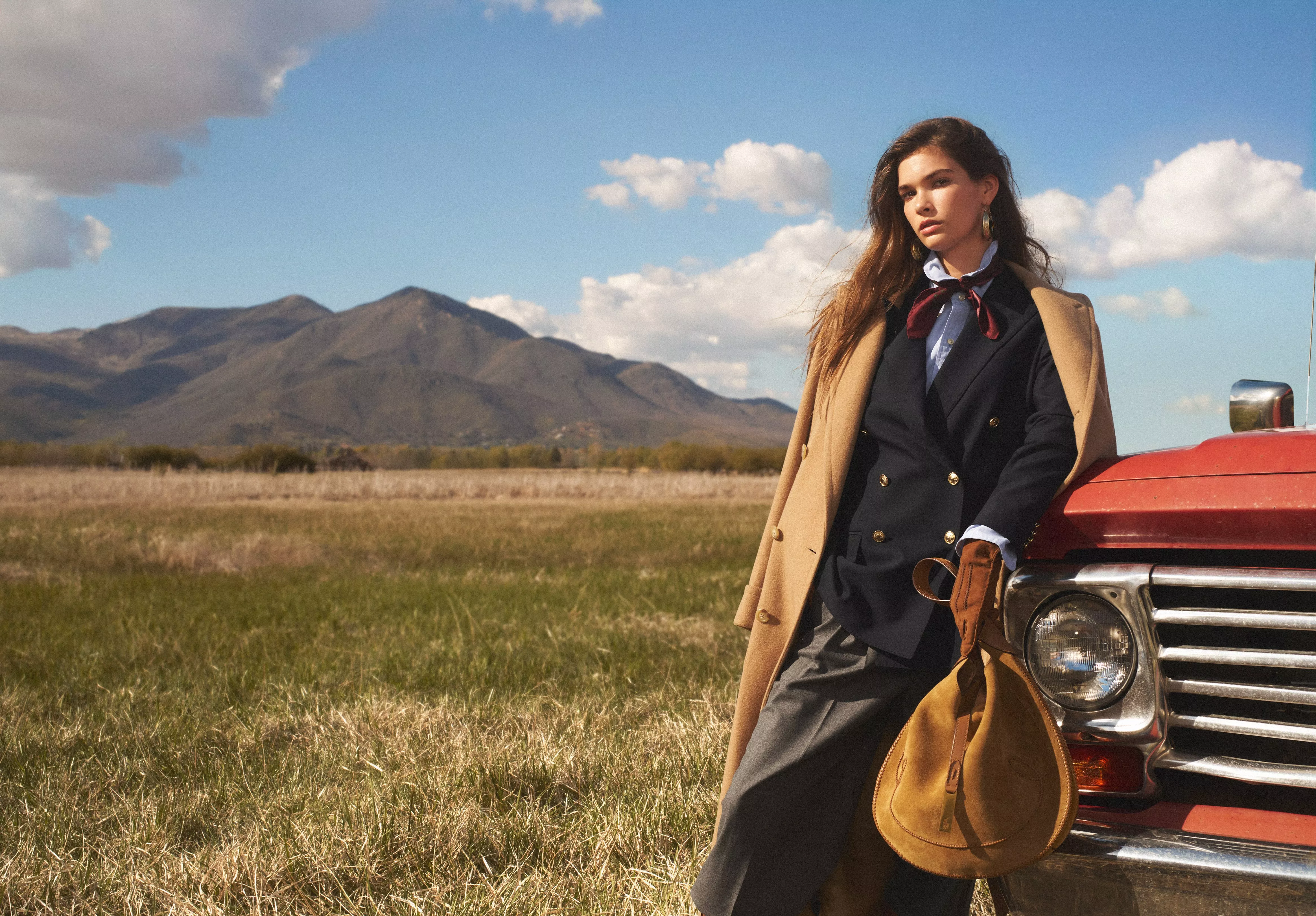 woman standing at the front of a red truck wearing Polo Ralph Lauren