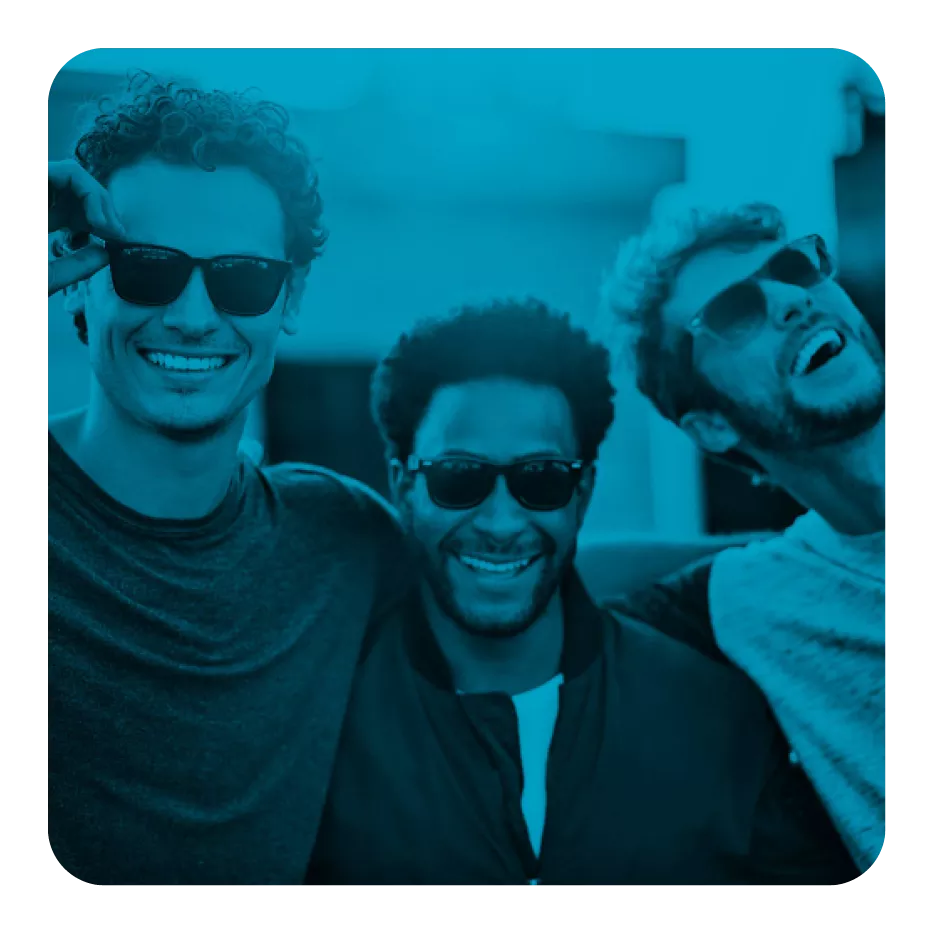 Three male friends wearing sunglasses, smiling and posing closely together, with a blue filter over the image.