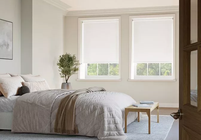 two white blinds in a bedroom