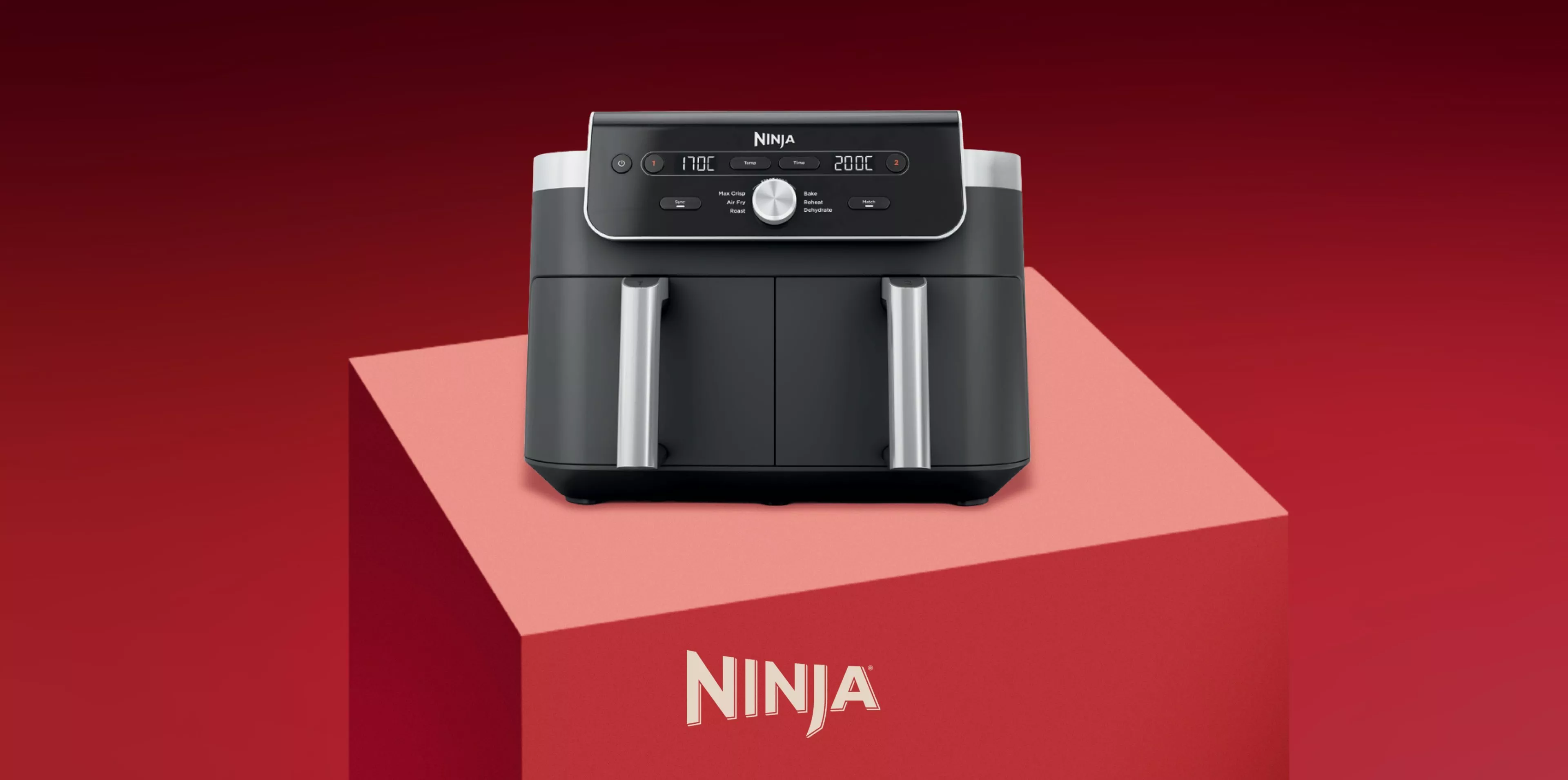 Ninja dual basket air fryer with digital control panel on red background, modern kitchen appliance product photo