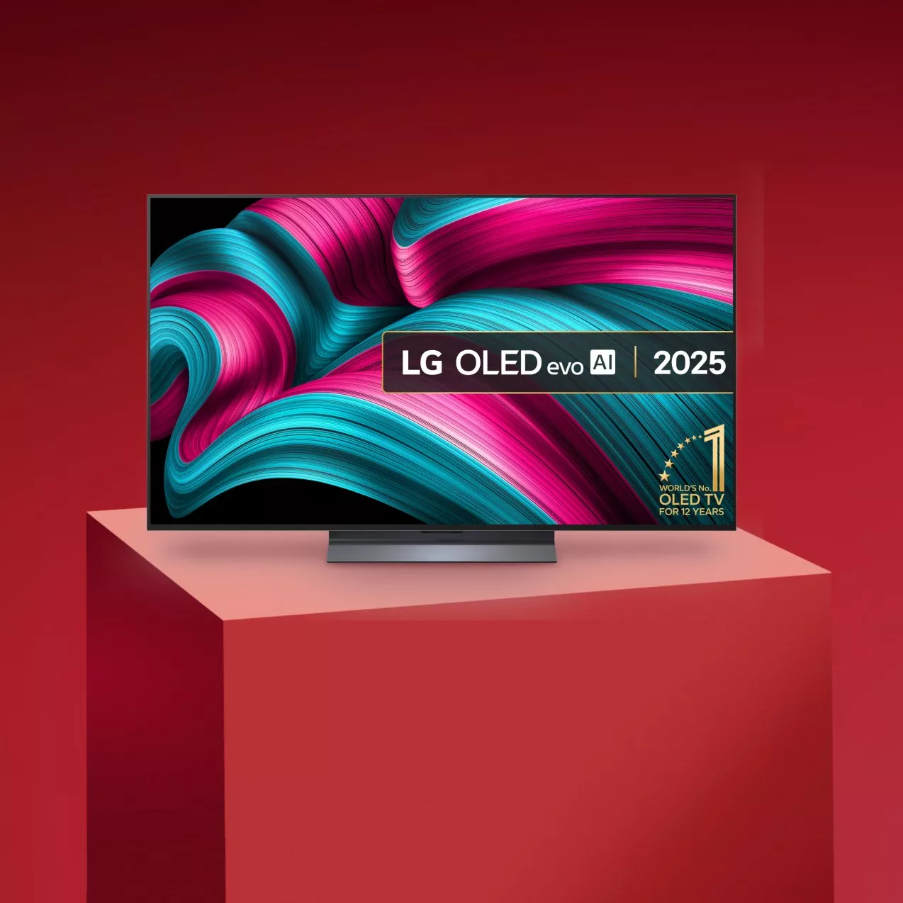 LG TV with pink and blue pattern on the screen, on a red background