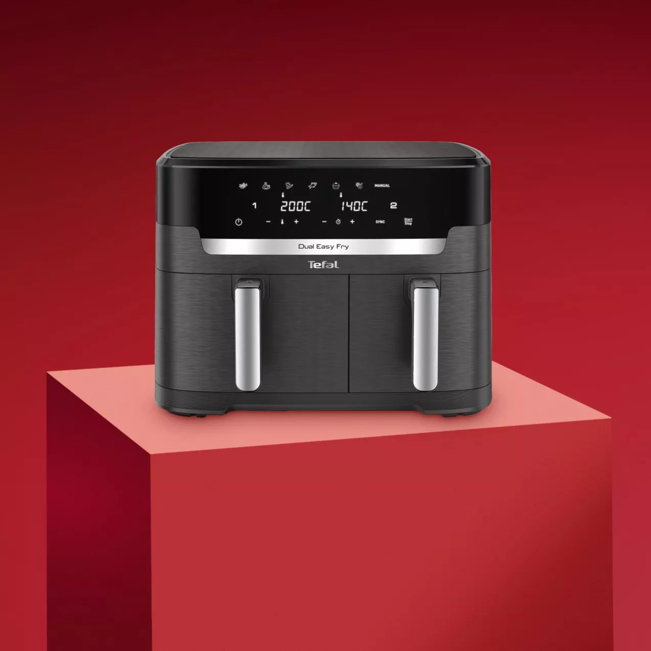 Black air fryer on a red background