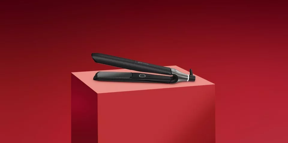 ghd styling straighteners on red block and red background 