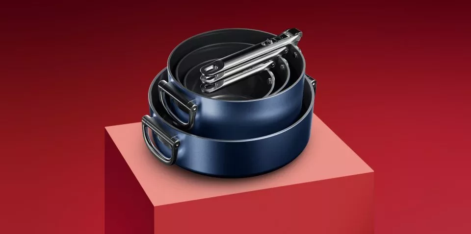 Stack of Joseph Joseph pans on a red background