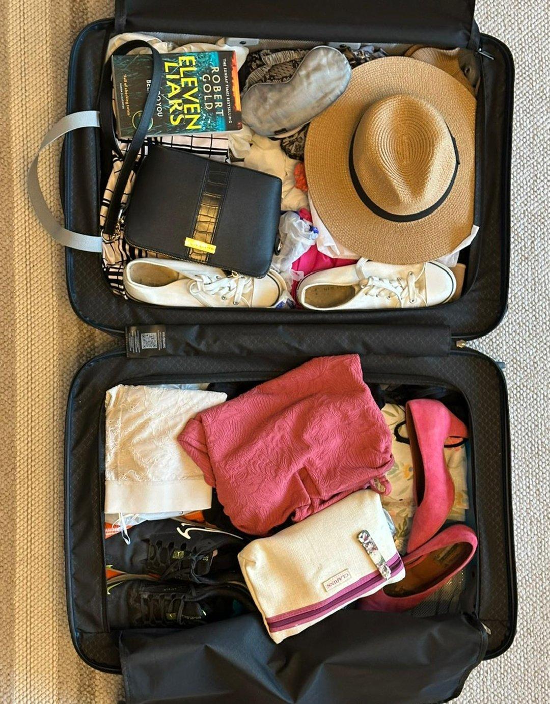 Inside of the suitcase with someones belongings in it