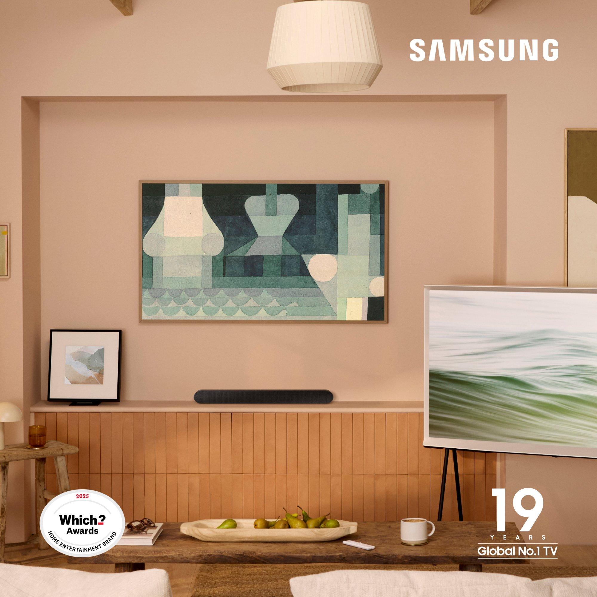 Samsung TV displayed in Art Mode with abstract artwork, wall-mounted above a soundbar; “19 Years Global No.1 TV” and “Which? Awards 2025” logos are visible.