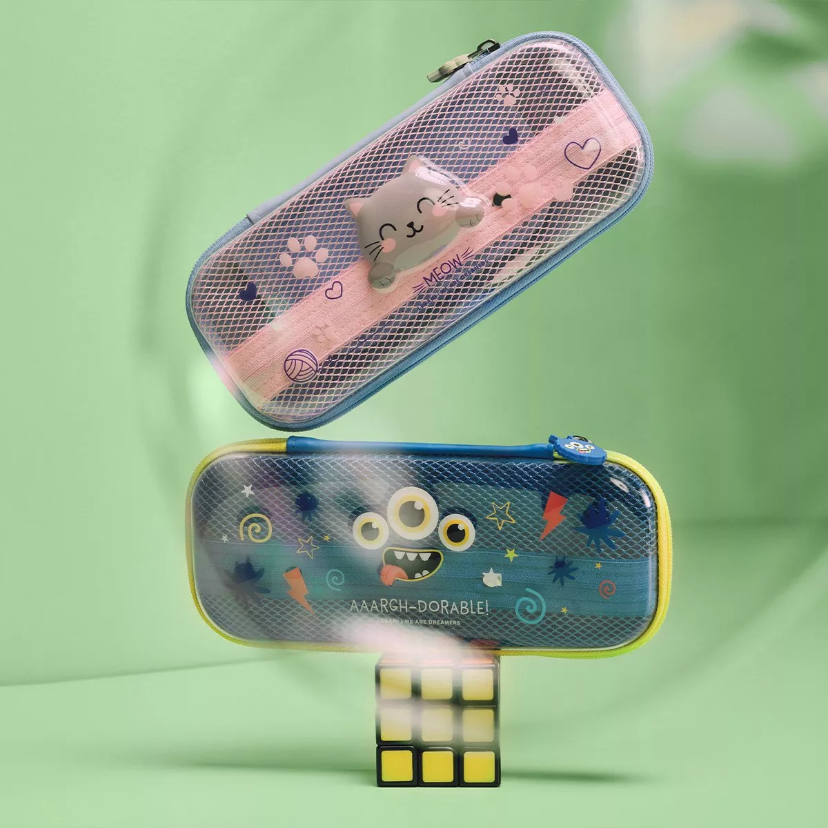 a cat themed pencil case above an alien themed pencil case