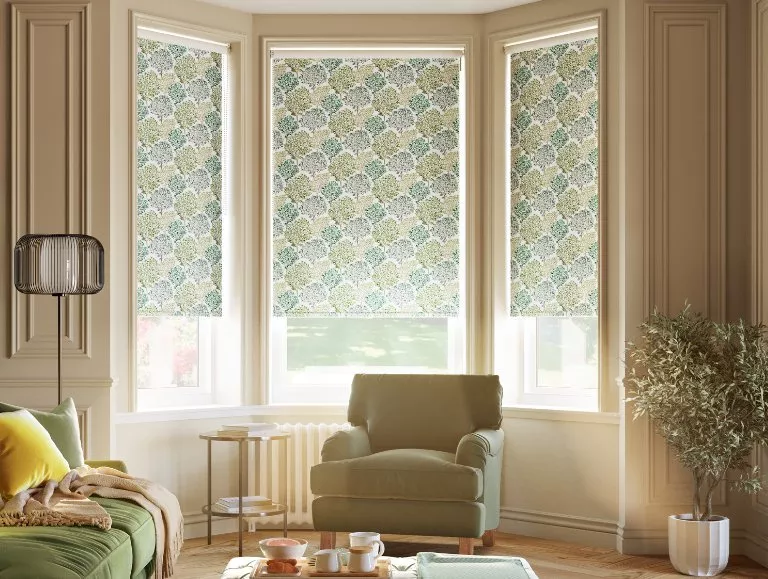 Green and blue floral blinds on a bay window of a living room 