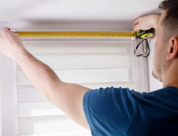 Person measuring a window