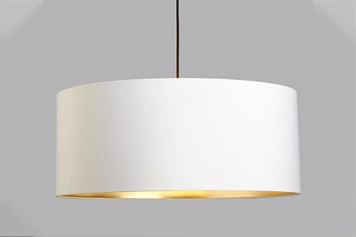Modern white drum pendant ceiling light with warm gold inner lining, minimalist hanging lampshade indoors