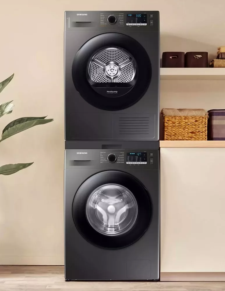 Washing machine and tumble dryer stacked one on top of the other in a laundry room