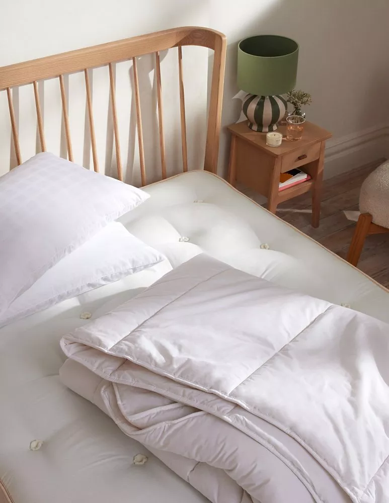 Mattress on wooden bedframe