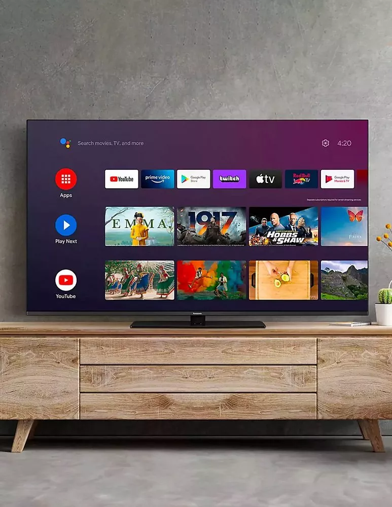 TV on top of wooden TV stand