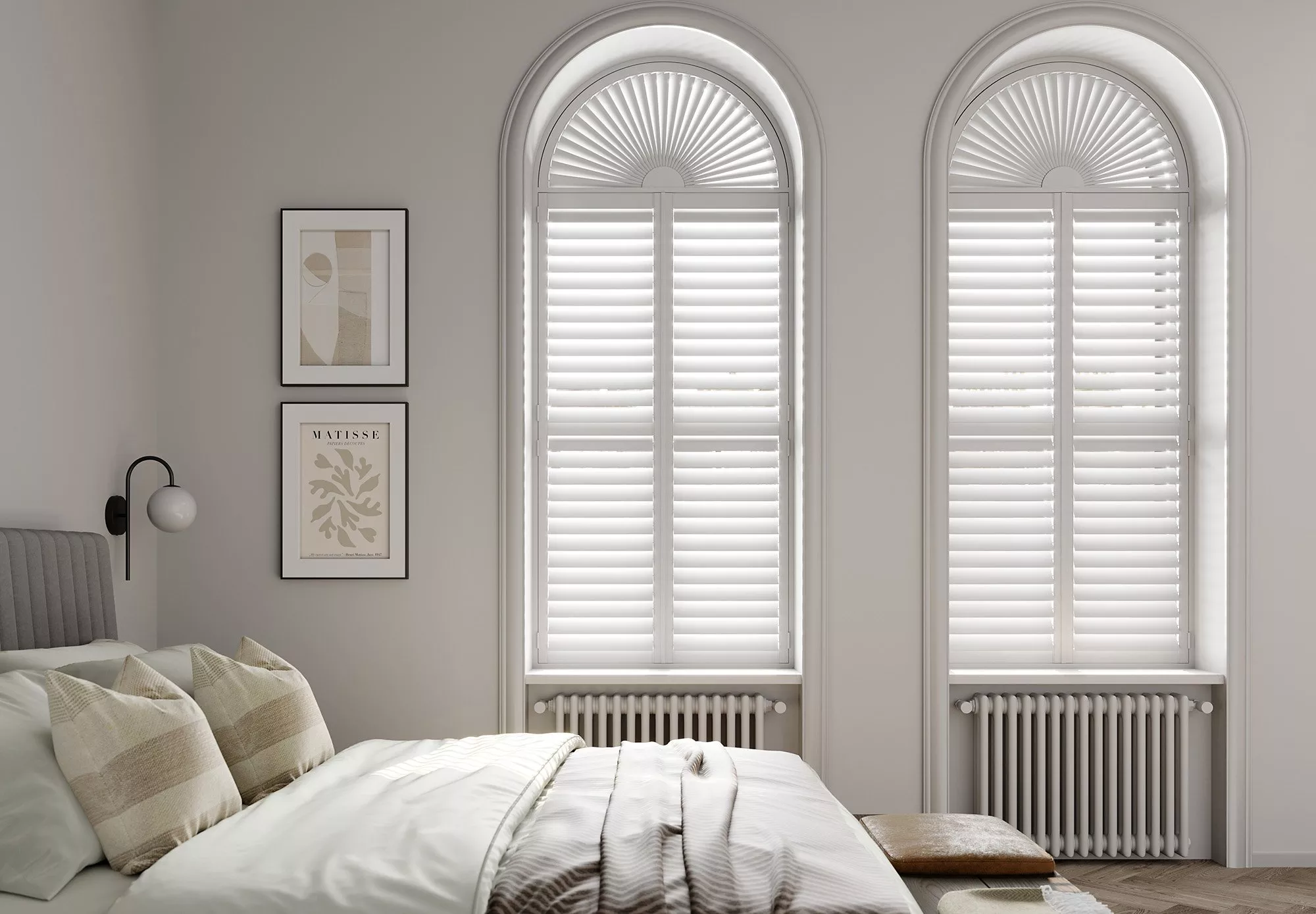 Bedroom with white shutters on arched windows