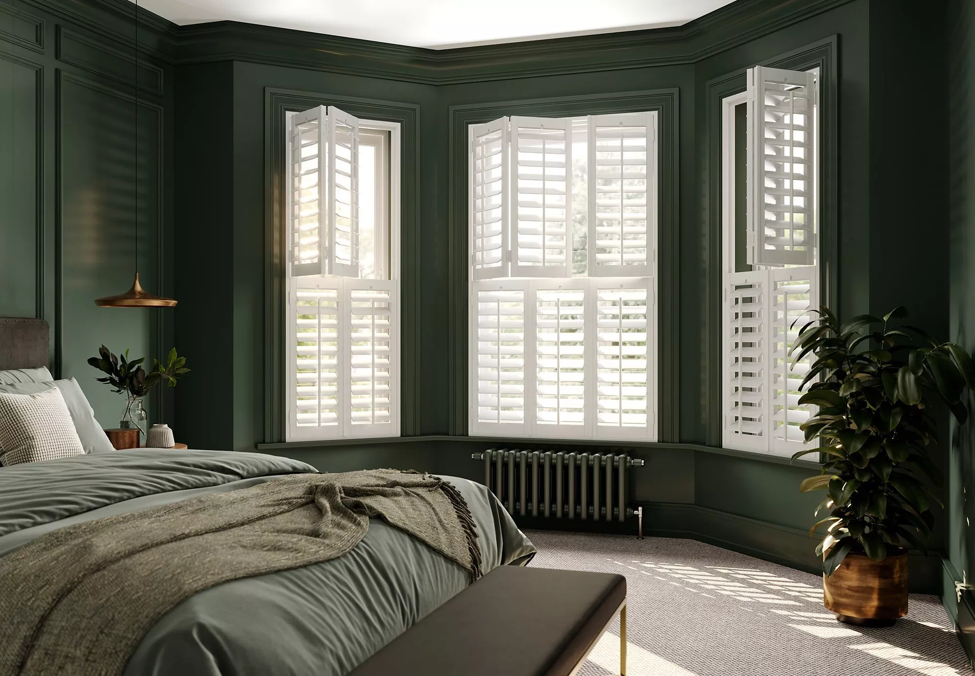 Green bedroom with bay window fitted with white wooden shutters