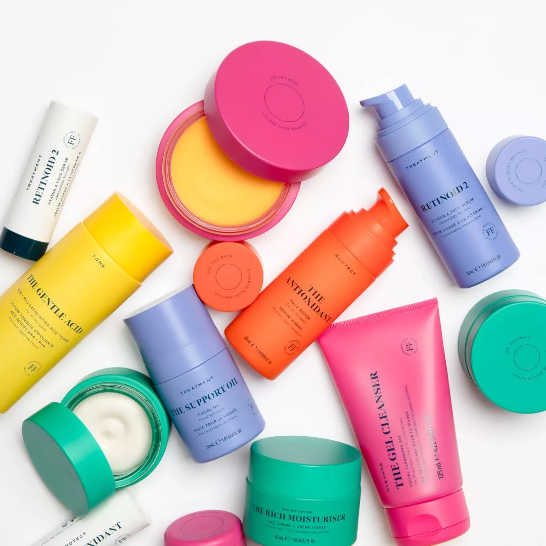 A colourful array of skincare products, including cleansers, moisturisers, and serums, arranged on a white surface.