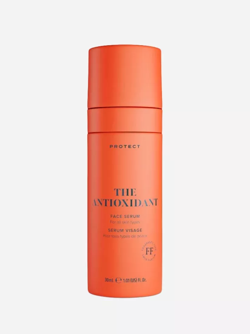 Bright orange bottle of face serum labelled "The Antioxidant" for all skin types, 30ml, on a white background.