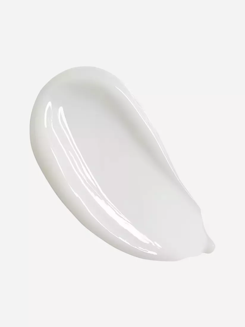 A smooth, glossy white lotion smear on a light grey background, showcasing its creamy texture.