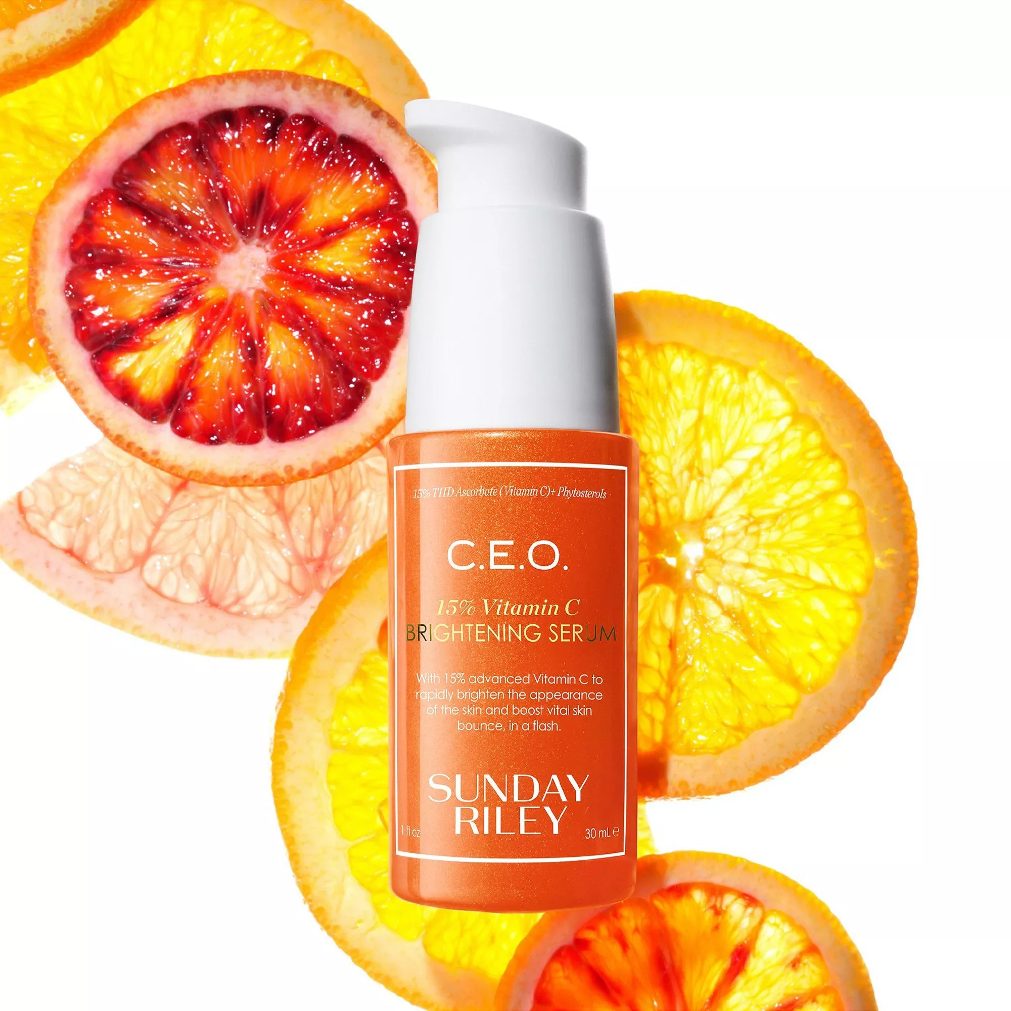 Sunday Riley C.E.O. 15% Vitamin C brightening serum bottle with sliced blood orange and citrus backdrop
