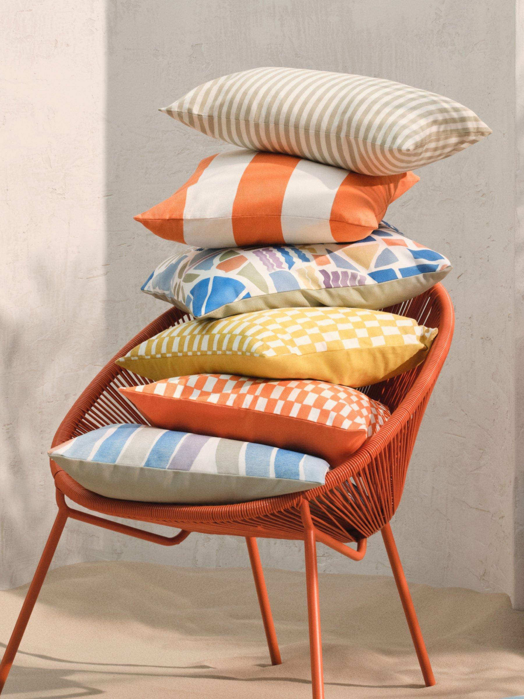 a garden chair with multiple cushions stacked on it