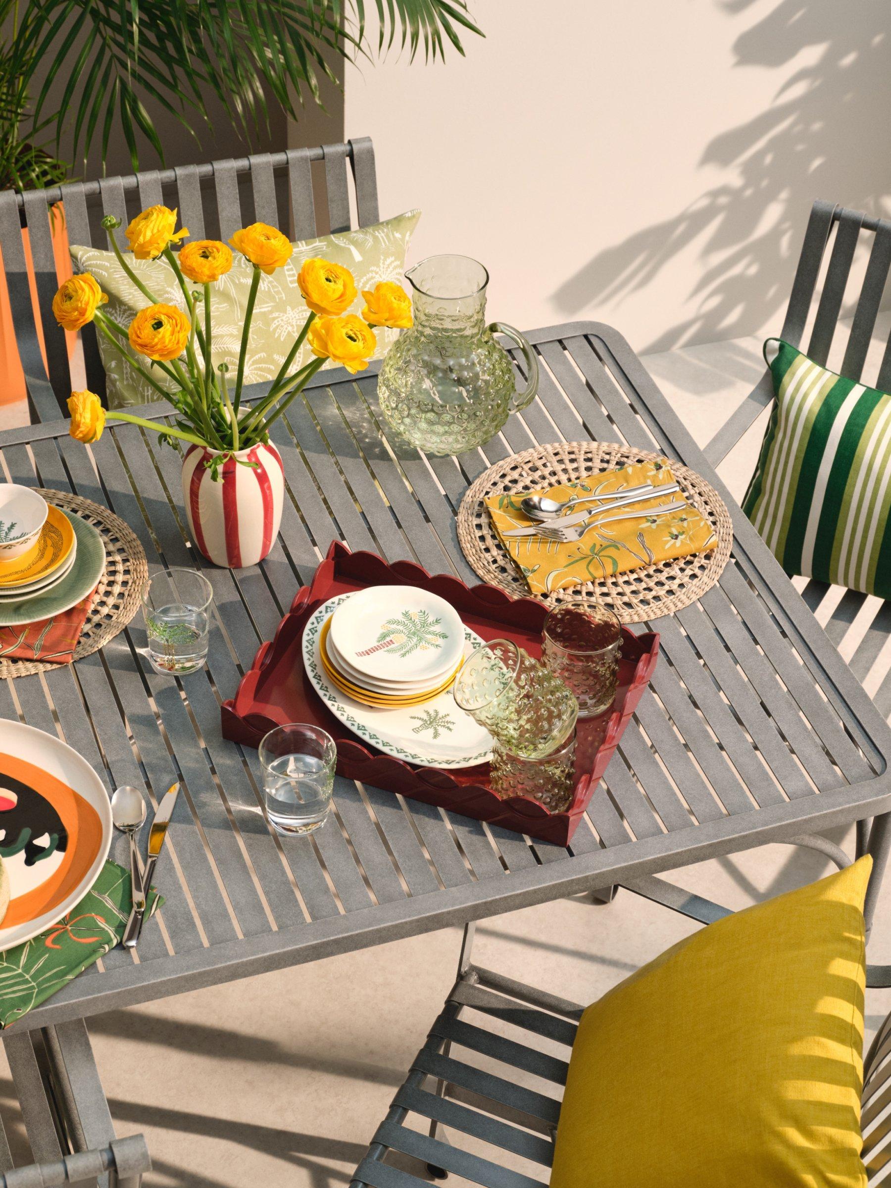 metal garden table with plates on it