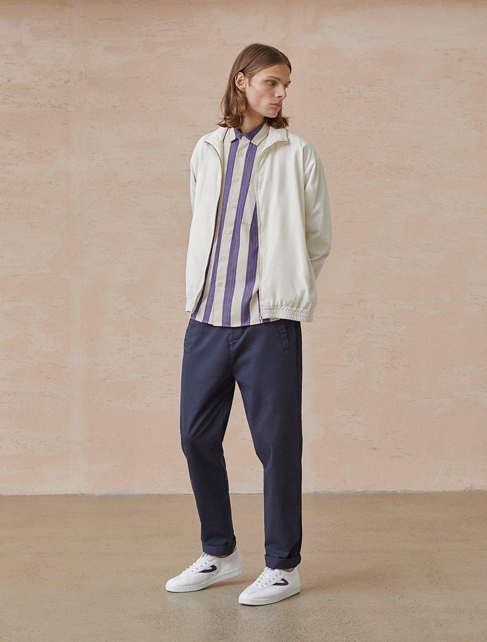 Model in navy chinos