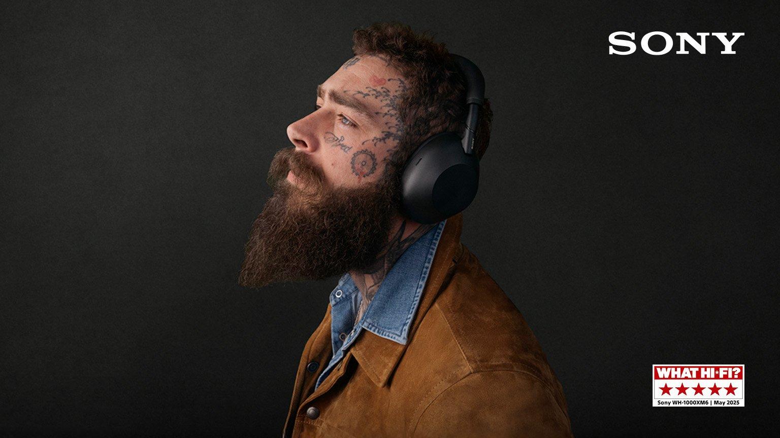 Post malone american singer and rapper wearing sony headphones, facing left, against a dark background.