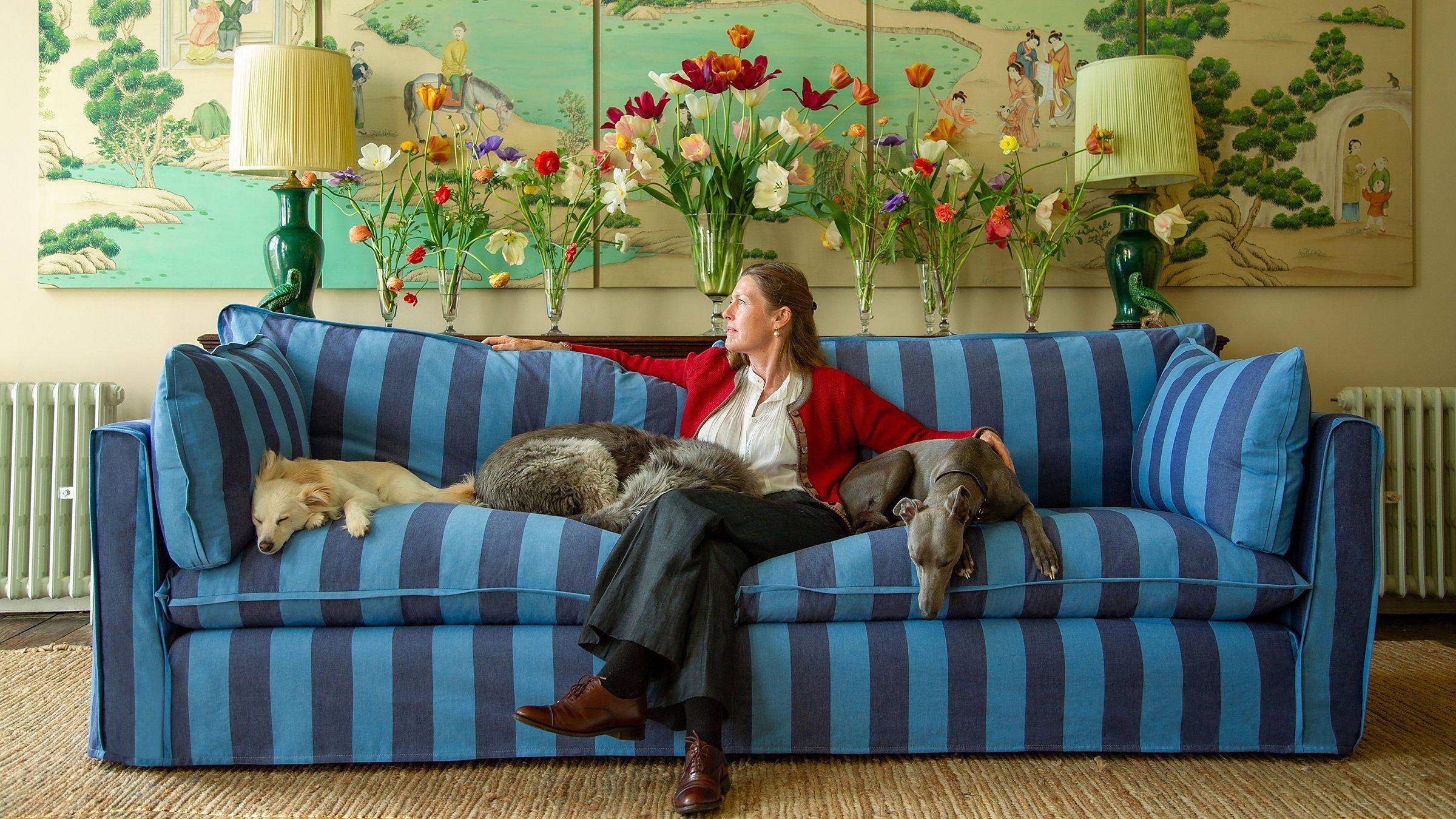 Sophie Conran sat on a blue striped sofa with dogs