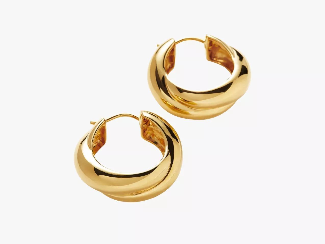 Pair of polished gold hoop earrings with a chunky twisted design, photographed on a white background.