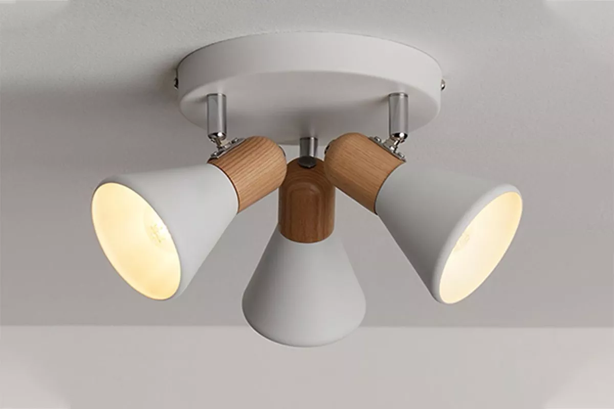 Modern white ceiling spotlight with three adjustable heads and wood accents, warm LED lighting for home interiors