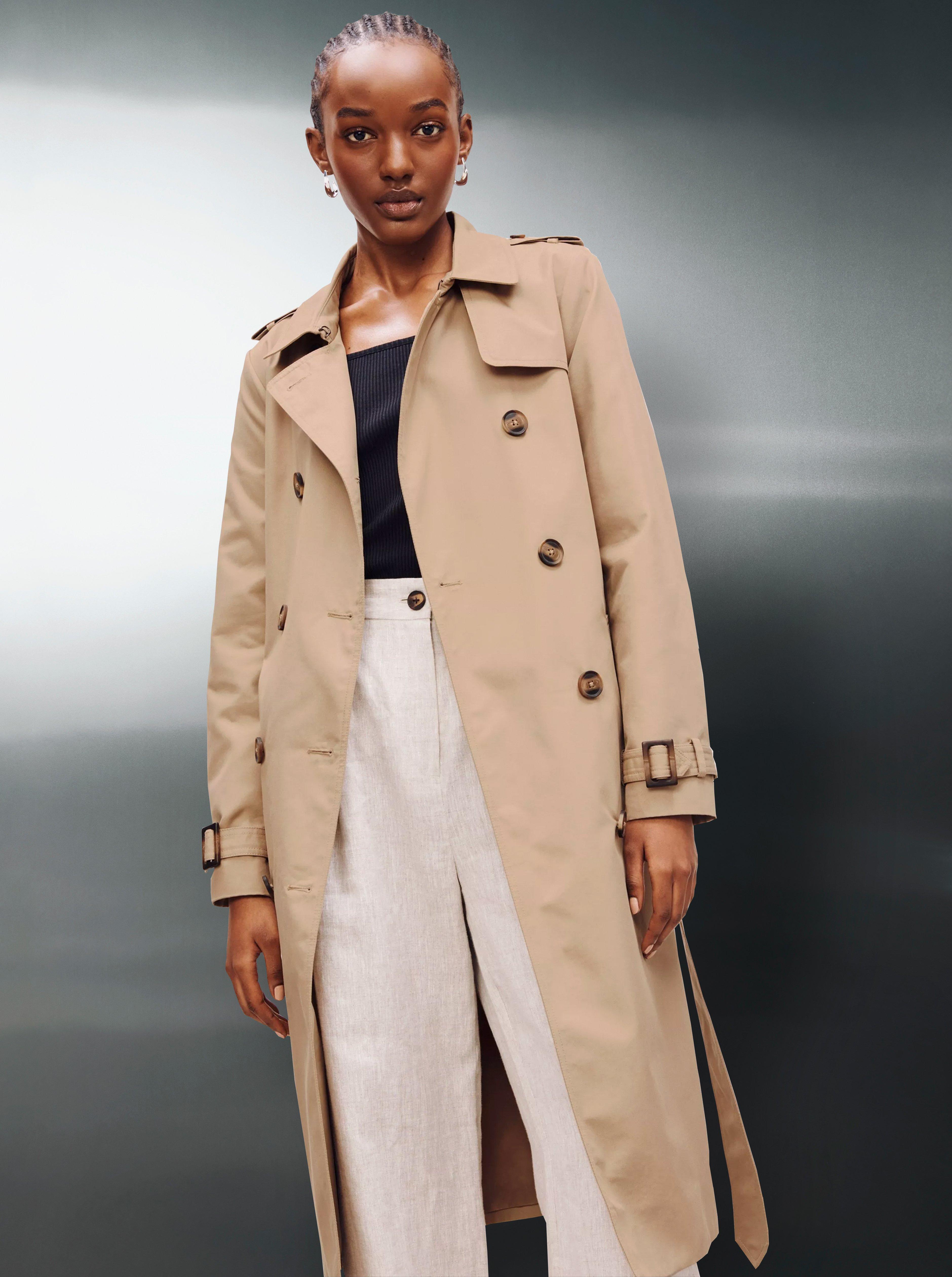 a lady wearing a beige trench coat