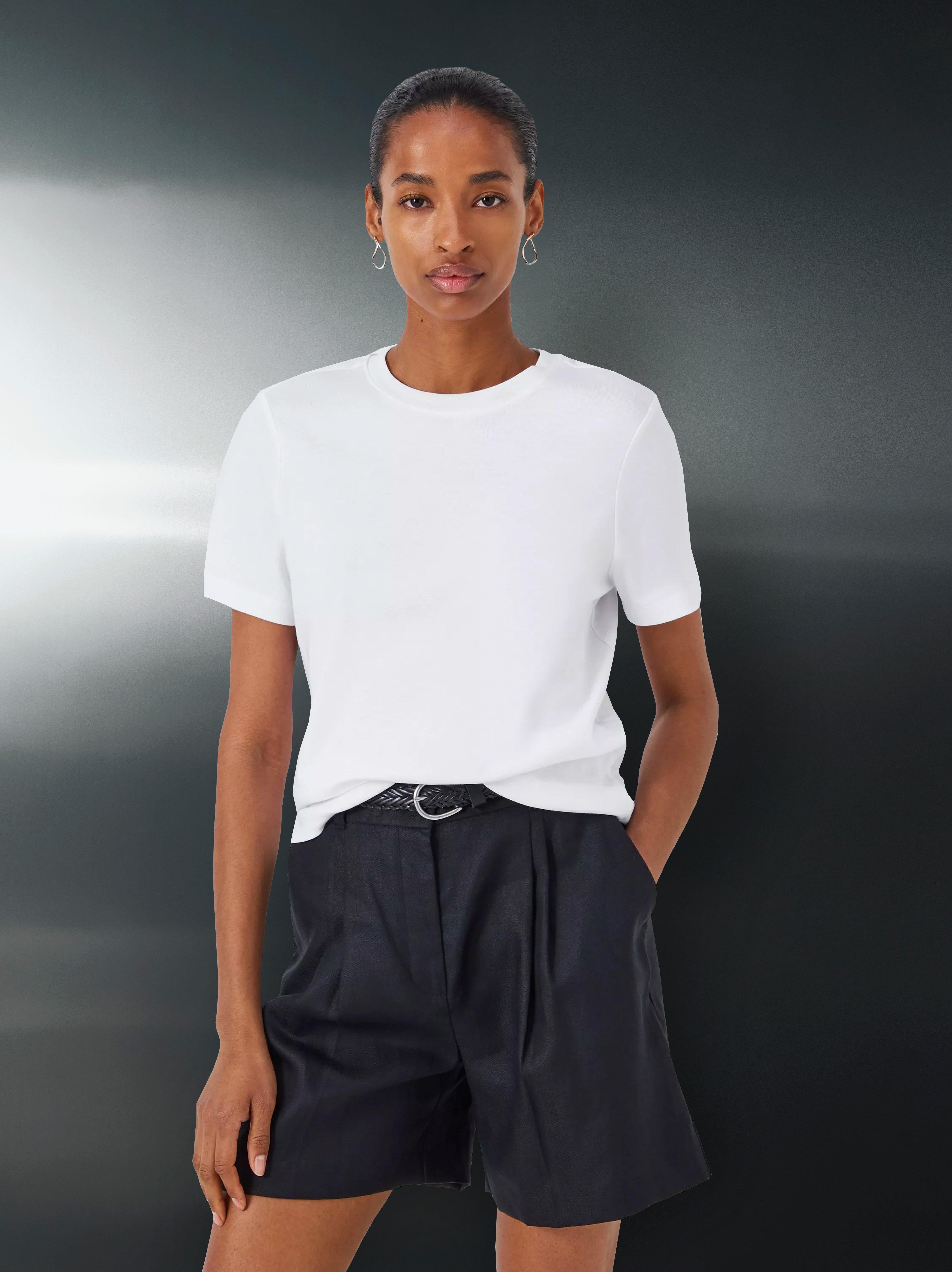 Image of a lady wearing a white t-shirt and black shorts