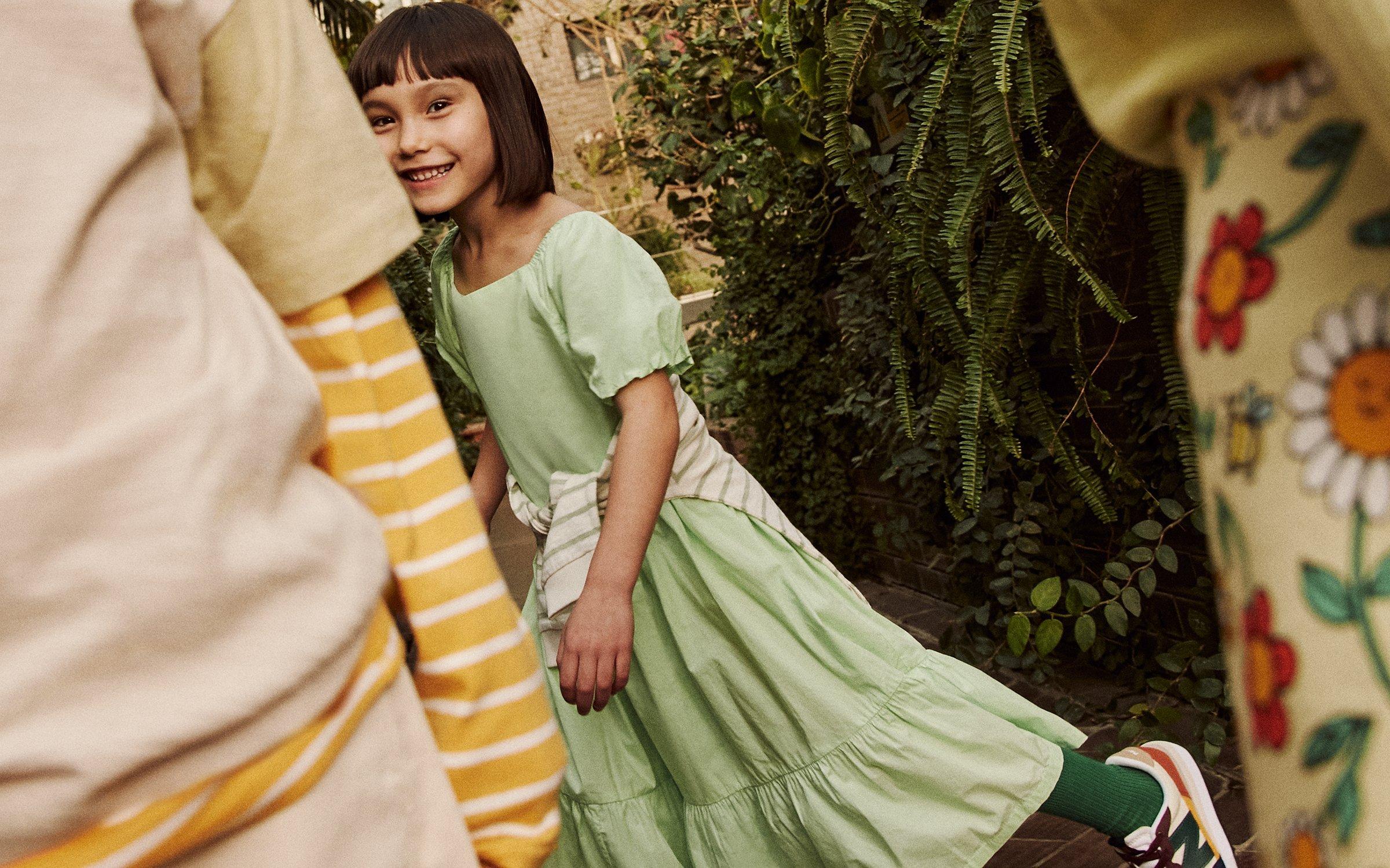 Children playing outside wearing John Lewis & Partners