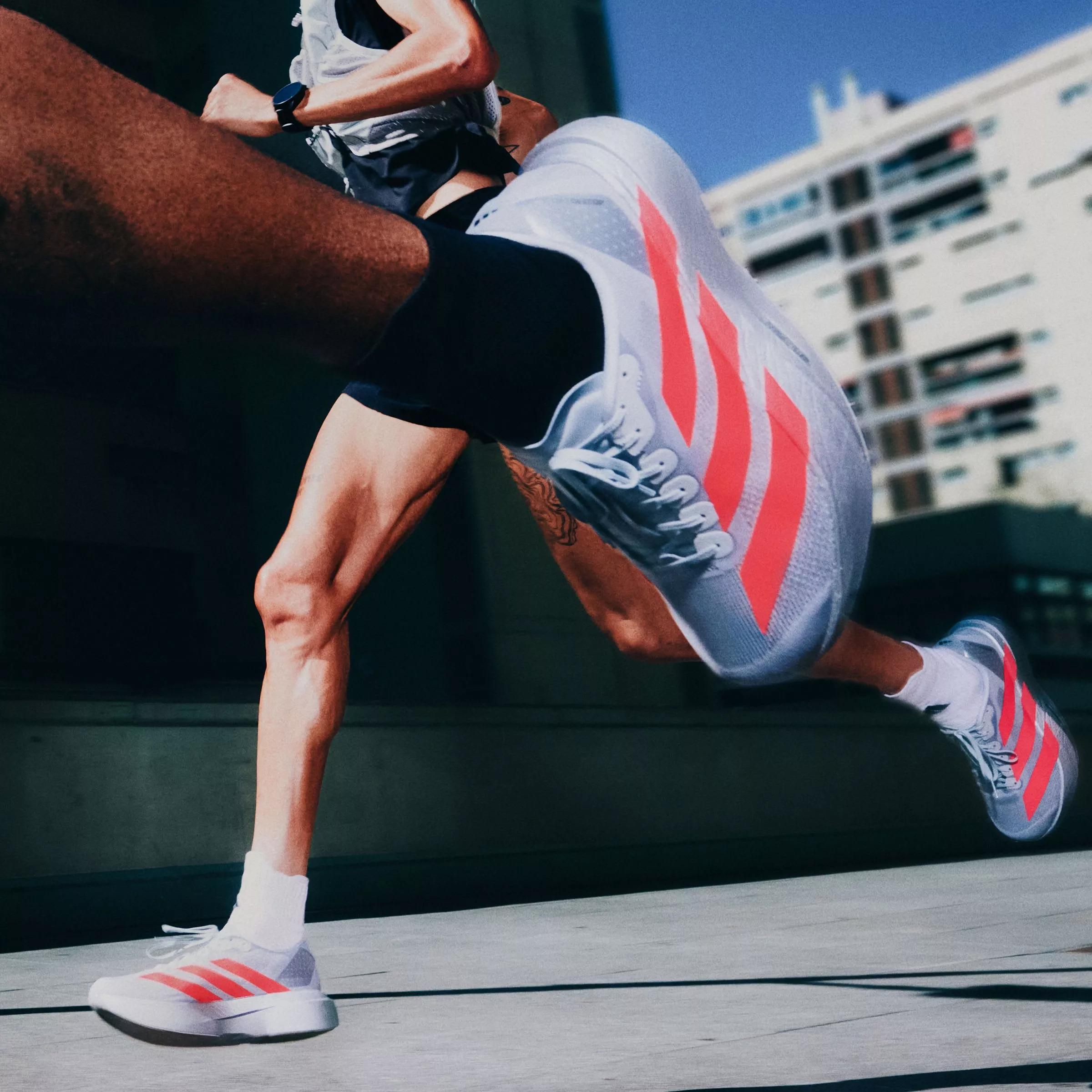 close up of two women running past so you can see their adidas running shoes