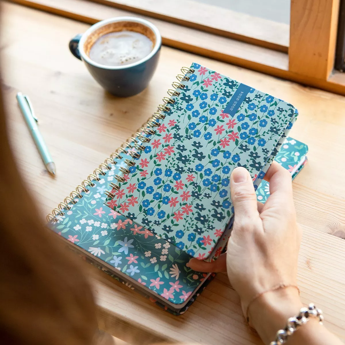 Fabric desk organiser tray holding tablet, notebook, scissors, ruler, cable and stapler on a marble worktop