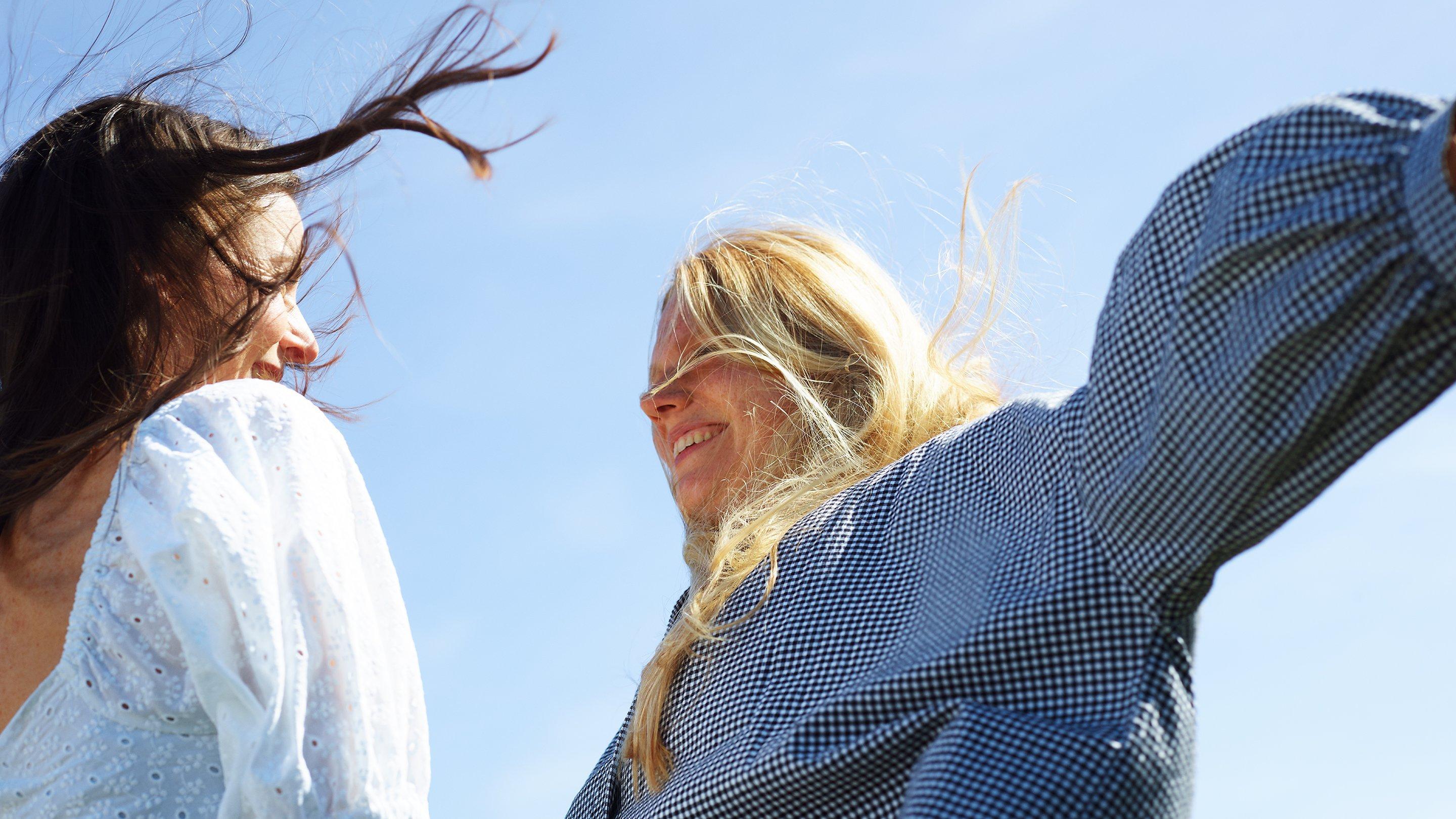 Staycation - Two ladies jumping in summer attire