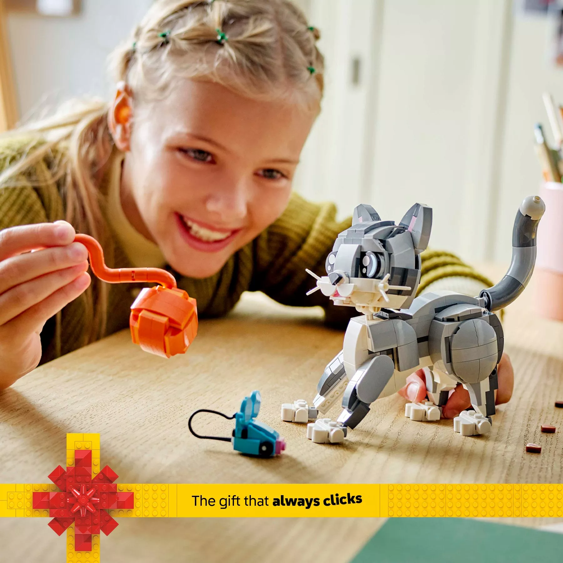 Girl playing with LEGO Creator 3in1 Playful Cat Figure, Toy Animal Set 31163