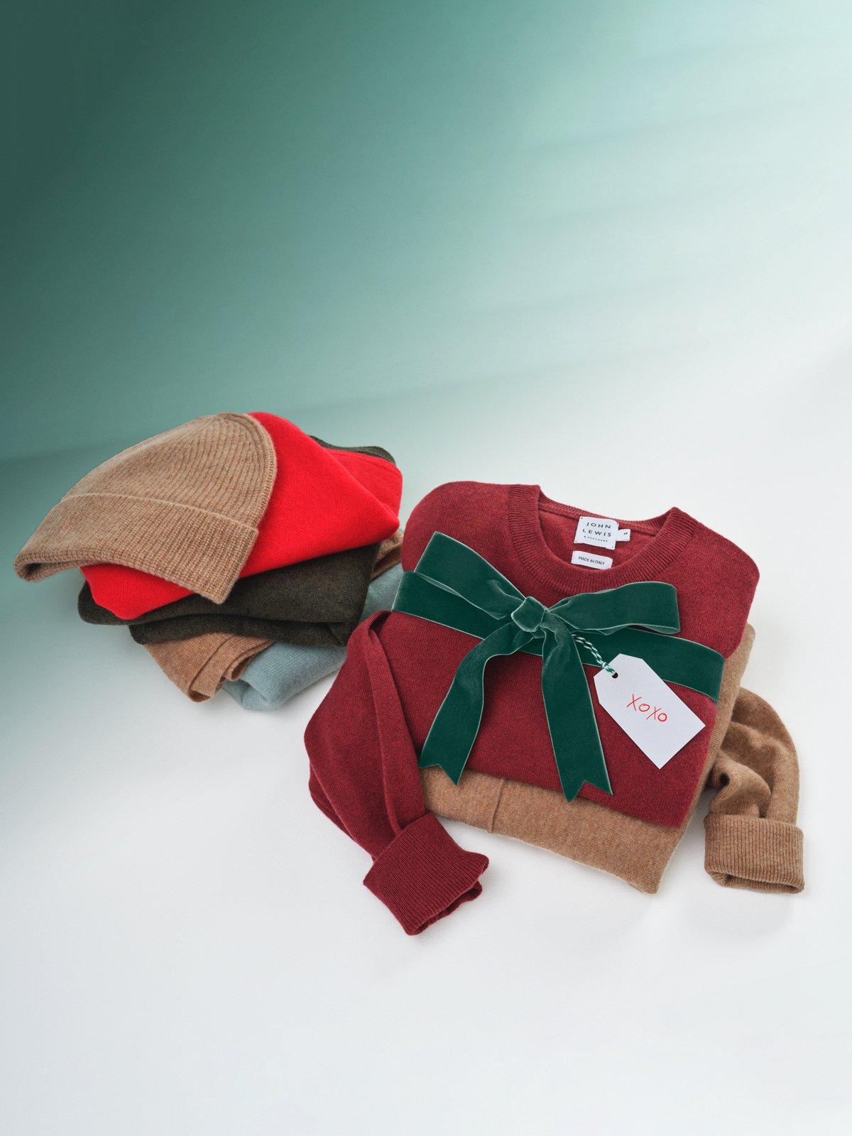 Image of an Xmas jumper and pile of scarves