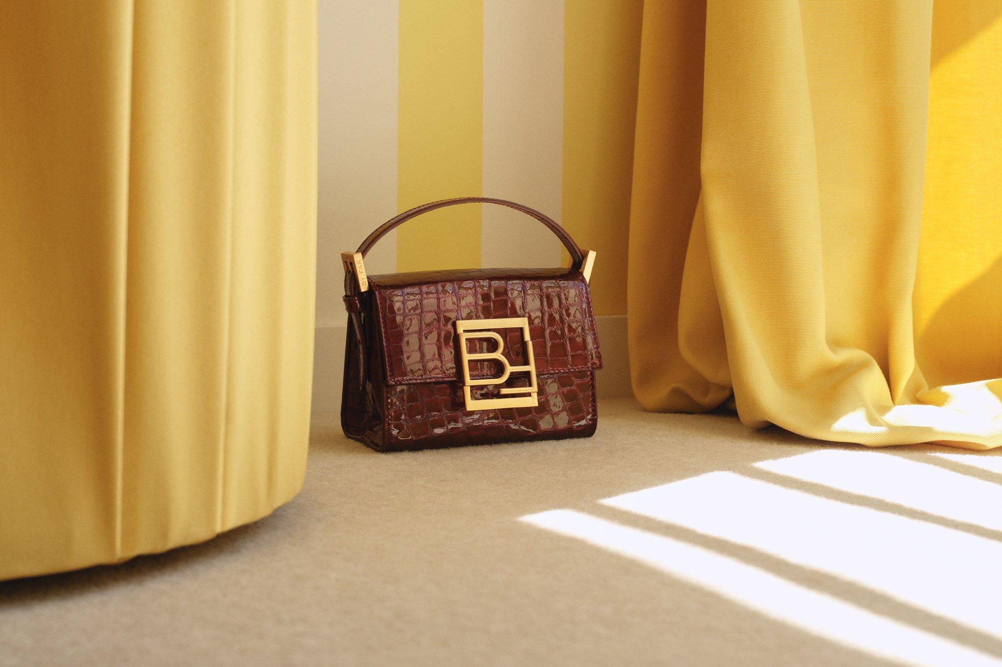 Image of a stylish bag on a yellow curtain backdrop