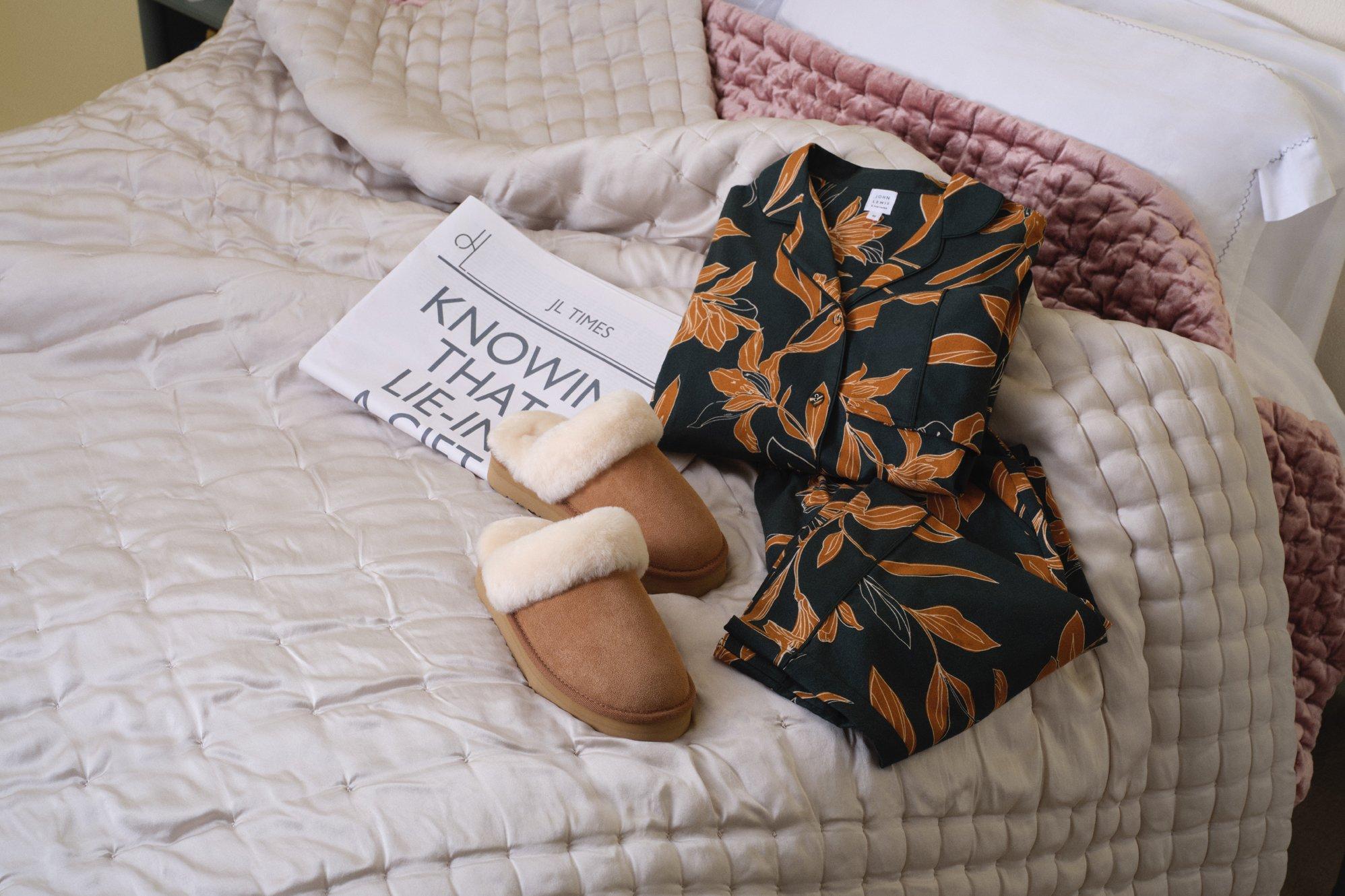 Image of PJ’s and a newspaper on a bed