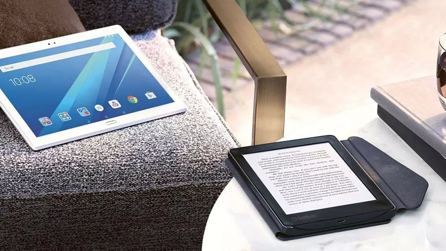 Tablet on a chair and kindle on a table 