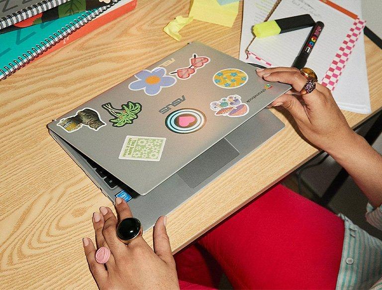 Person opening laptop