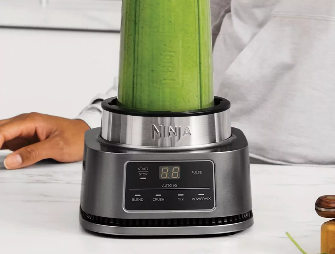 Ninja blender with green smoothie blended inside