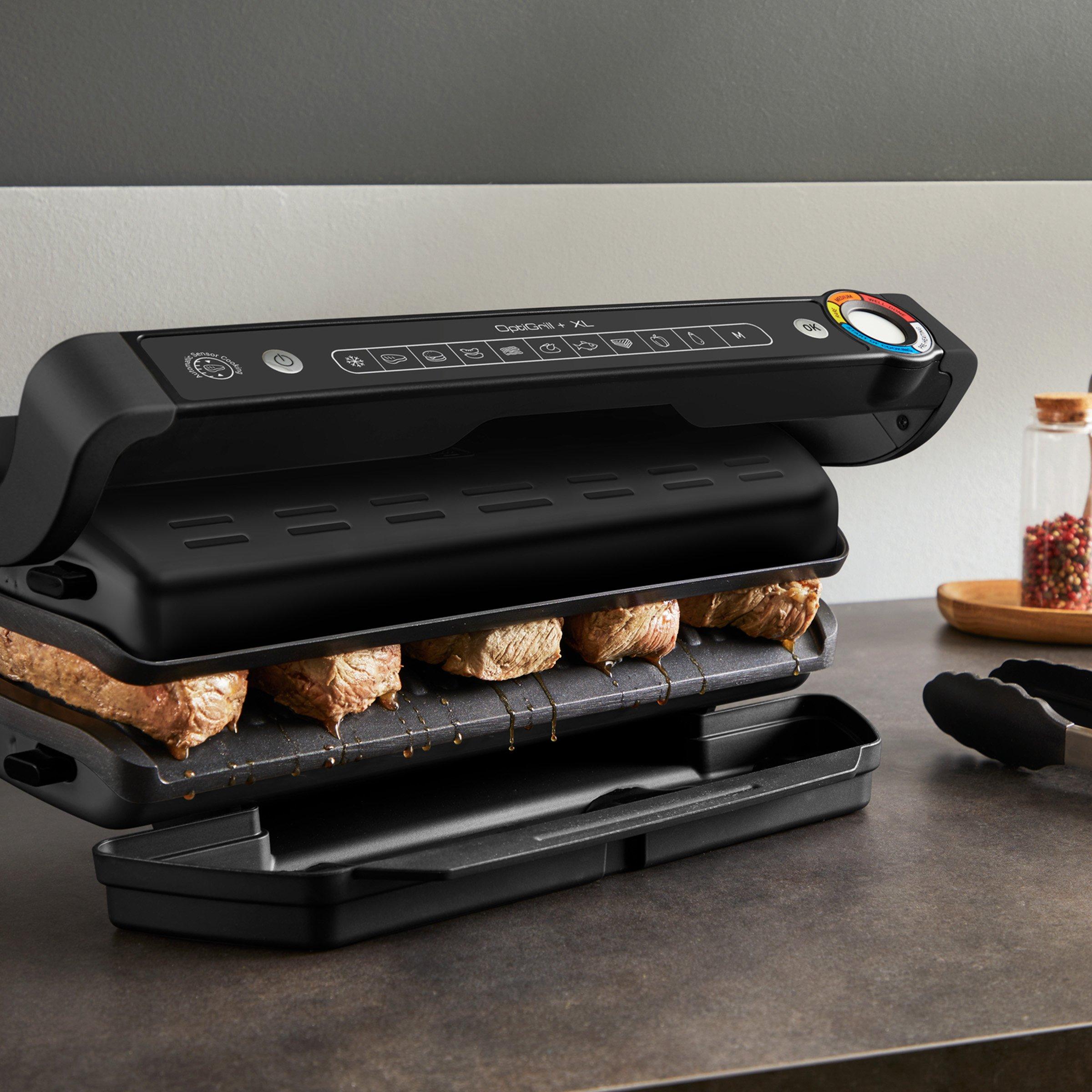 black tefel modern electric indoor grill, meat cooking on the grill plates