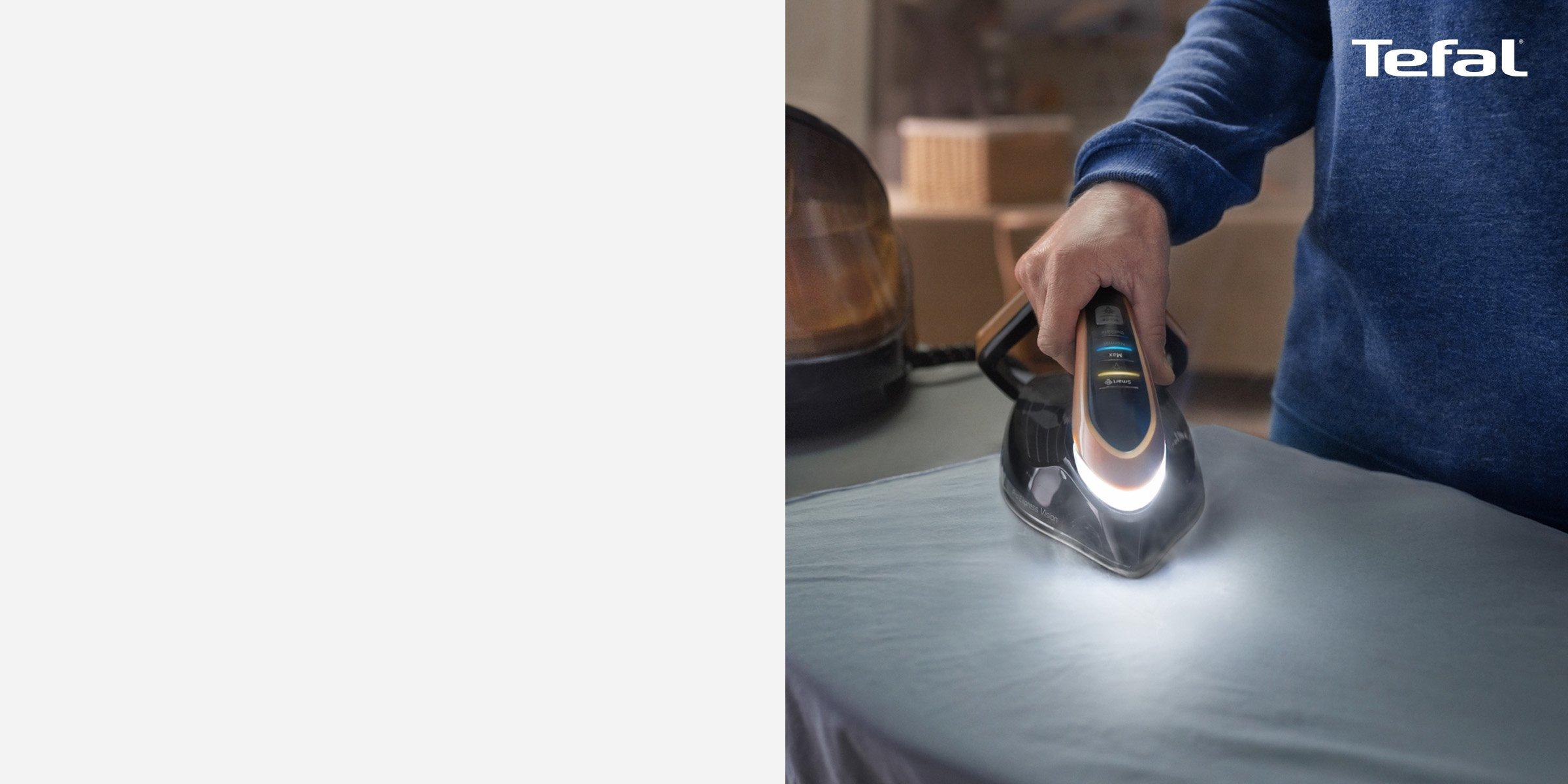 tefal iron pro in hand with light on table