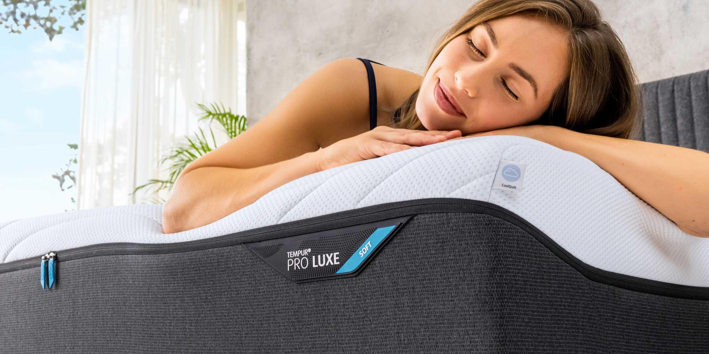 Woman looking cosy on a Tempuh Pro Luxe mattress